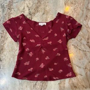 Cute red top w/ small pink flowers. V-neck drop. Size S-M